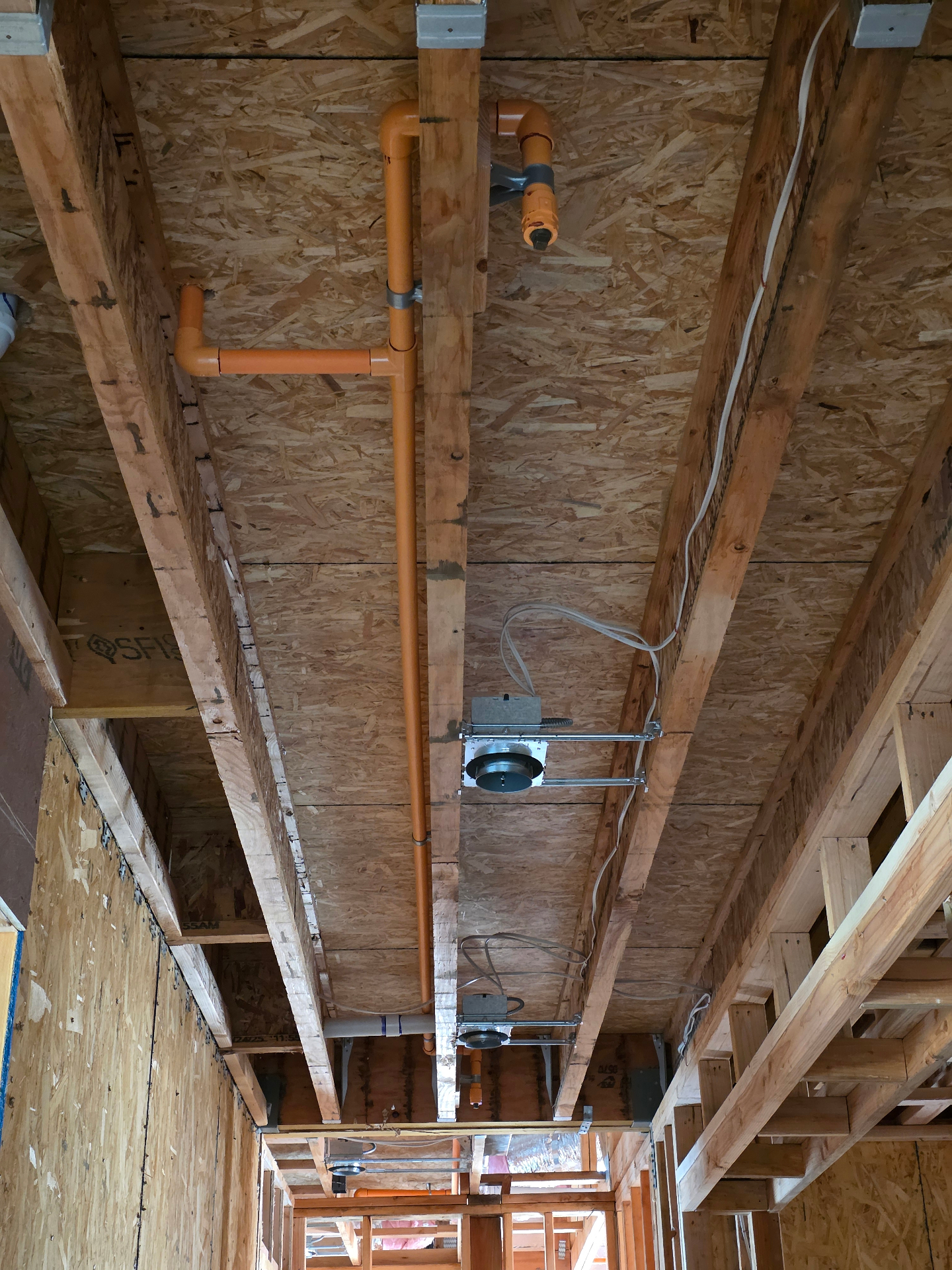 Orange CPVC fire sprinkler piping rough-in with drop for a sprinkler head